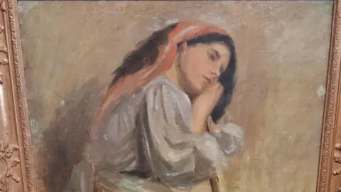 Leonard Cheshire A painting believed to be by artist Stanhope Alexander Forbes. It shows a woman sat on a stool leaning on a broom.