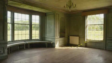 An image of a grand sitting room that has seen better days - with a bay window which has a rounded bench seat and another large window with a branch of greenery growing through it. The walls are a shabby, mouldy-looking pale green colour and the wooden floor is dirty.