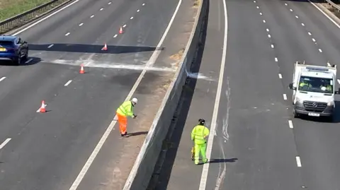 Jozef Hall/BBC Workers assessing the road