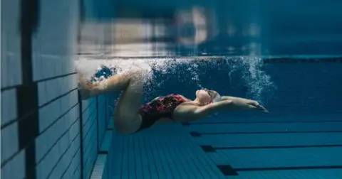 Getty Images A female swimmer underwater