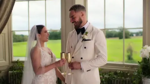 Netflix A woman and man in white dress and tux on their wedding day