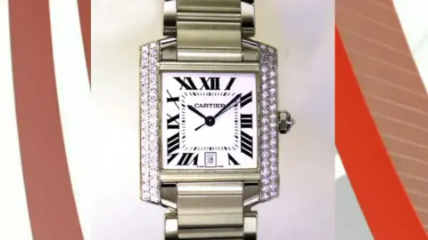 West Yorkshire Police A silver wrist watch with the word 'Cartier' on the watch face. 