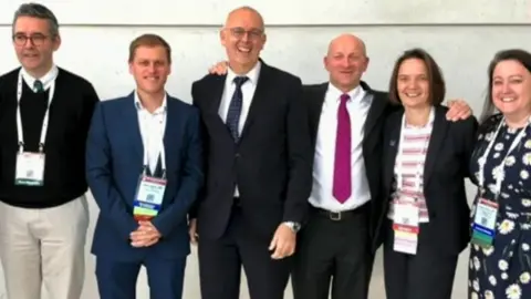 Newcastle hospitals Professor Jackson (fourth from left with purple tie) and his team