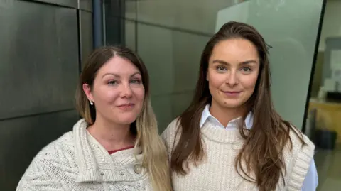George King/BBC Two woman - both wearing cream coloured knit wearing - standing in front of a window at Ipswich Crown Court