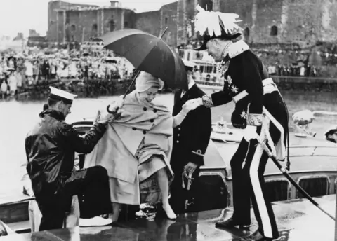 Keystone/Getty Images Queen Elizabeth II disembarks from the royal barge at Carrickfergus in 1961