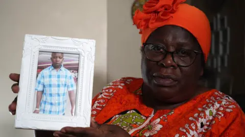 Jamie Niblock/BBC Angelina Patterson with picture of her son Charles