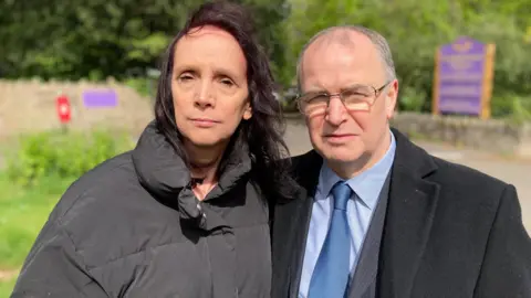 Image of Sarah and Paul standing outside