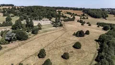 PA Media A view of Ashton Court Estate in Bristol, where the grass is mostly dry and yellow.