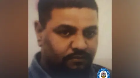 West Midlands Police A faded image of Zafar Medhi shows him with dark cropped hair and a dark moustache and beard