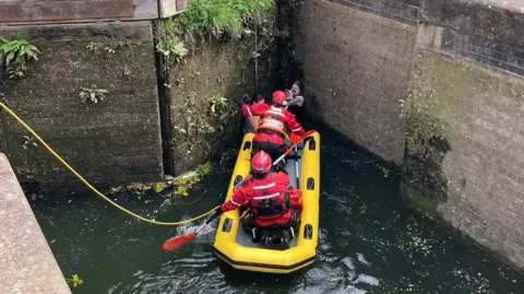 Boat being used to rescue dog and its owners
