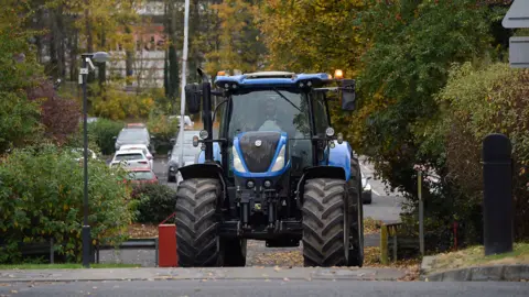 Pacemaker a large blue tractor in a wooded car park