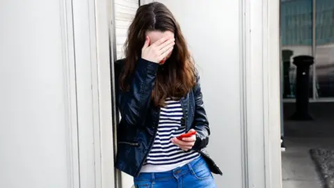 Science Photo Library Teenager with hands over her eyes