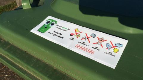 A sticker explaining what should not go into a recycling bin