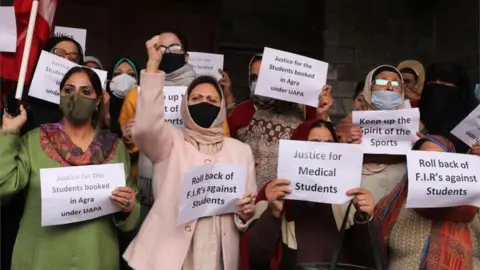 EPA Female supporters and leaders of the mainstream political party National Conference (NC) shout slogans as they hold placards during a protest in Srinagar, the summer capital of Indian Kashmir, 01 November 2021. Demonstrators demanded the withdrawal of police reports against students and for the release of three Kashmiri students arrested in Agra, Uttar Pradesh. The Indian Kashmir government has registered an open first information report (FIR) against the medical students at the Government Medical College (GMC) Srinagar and Sher-i-Kashmir Institute of Medical Sciences (SKIMS) for allegedly celebrating the Pakistan"s cricket team victory over India in the ICC Men"s T20 World Cup 2021.