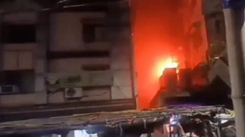 A late night view of the fire at a hotel building in Kolkata city, India. 