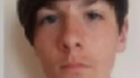 Merseyside Police A police mugshot of Sean Ryan, 21, who has dark brown hair swept to the side. 