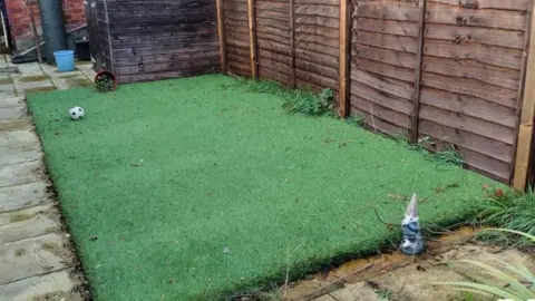 READING BOROUGH COUNCIL A tatty-looking patch of artificial lawn