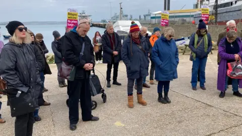 BBC People standing in silence at Portland Port