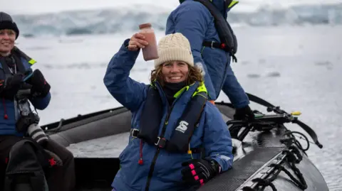 Paul Fahy/WWF Scientist Dr Sarah Kienle holds a sample jar of whale poo