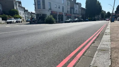 Getty Images Two double red lines along a road in Brighton. 
