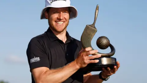 Peter Malnati holds the Valspar Championship trophy
