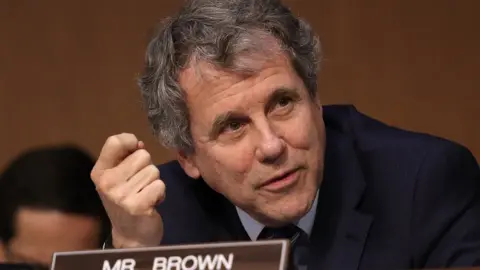 Getty Images Sherrod Brown speaks at a congressional committee hearing.