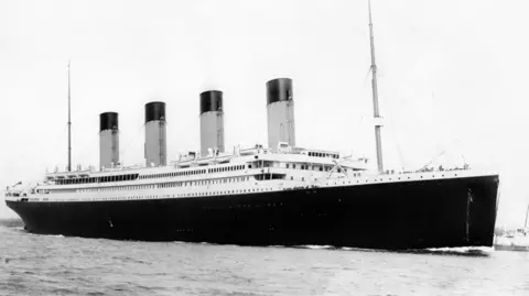 PA Archive A black and white photo of the found-funnelled Titanic in a dock before its doomed voyage