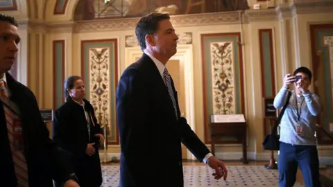 Getty Images FBI Director James Comey (C) leaves a meeting with Senators at the US Capitol on March 15, 2017 in Washington