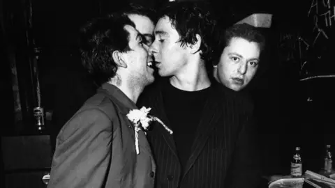 Getty Images Steve Diggle, Pete Shelley and Garth Smith of Buzzcocks