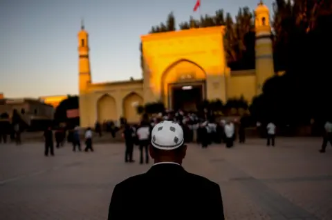 Getty Images A man arrives for morning prayer in Kashgar, Xinjiang, a mostly Muslim region in north-western China