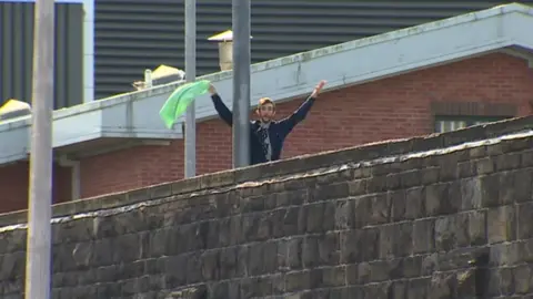 BBC An inmate has climbed up an internal fence at Cardiff prison