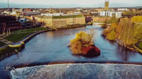A swollen Derwent passing through the centre of the city viewed from above