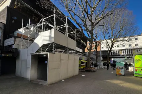 A fire exit at HMV Empire in Coventry consists of a concrete and scaffold construction outside the front of the venue. 