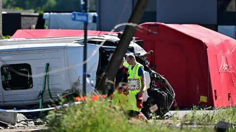 Emergency services pictured at the scene of an accident between a train and a minivan, at the railway crossing Vierhuizen, in Buggenhout, Tuesday 26 May 2026