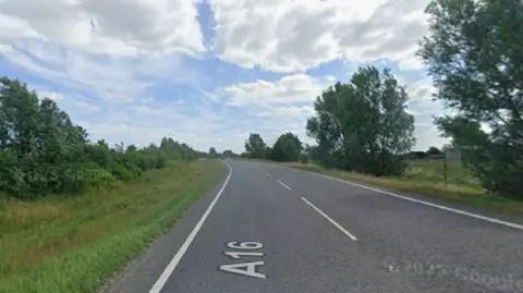 Google A screenshot from Google maps showing a rural A road with trees and grass either side.