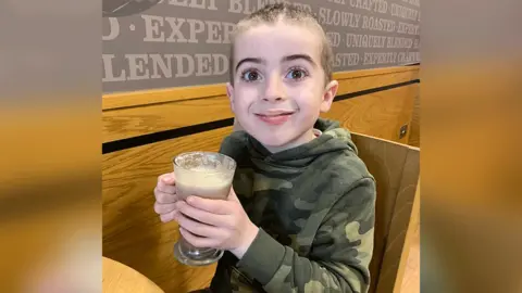 Family Photo Caleb enjoying a drink