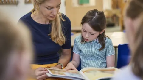 Getty Images A female teacher with a pupil