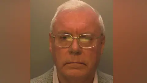 An elderly man with glasses. 