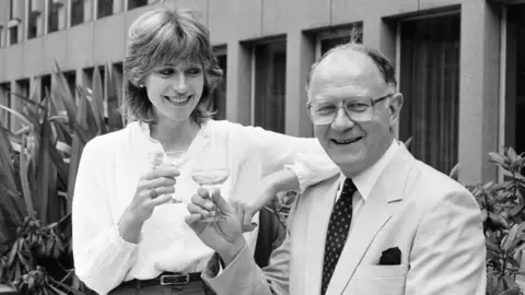 a man and a woman toasting with champagne glasses