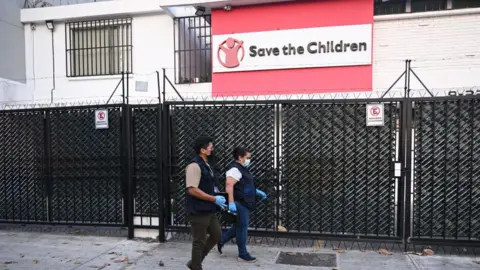 Two officers walking past the outside of STC office in Guatemala