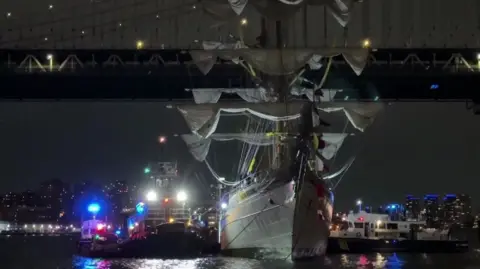 Damaged ship next to bridge 