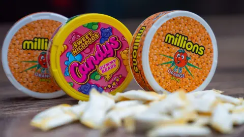 BBC Three circular tubs of nicotine pouches being sold in packaging resembling children's sweets, called 'millions' and 'sweet nicopods candys gummy bears'.