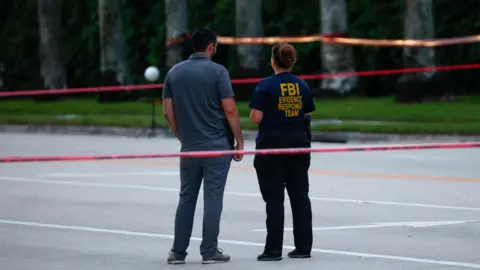 Reuters Officials walk past the scene of an attempted assassination of Donald Trump