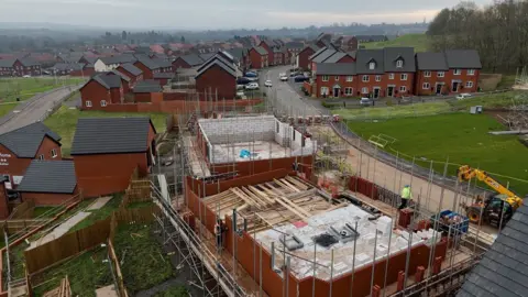 An aerial photograph shows houses being constructed on the edge of the Brockhill estate, one of Redditch's newest housing developments. 