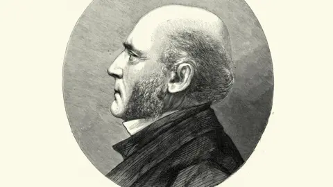 Getty Images Vintage illustration of George Gilbert Scott, a prolific English Gothic revival architect, chiefly associated with the design, building and renovation of churches and cathedrals. 19th Century. He is facing to the left of the picture and is in profile, wearing a dark jacket with a white wing collar.