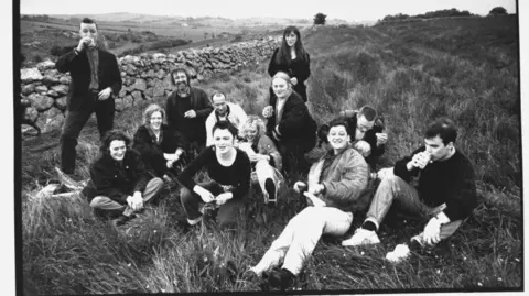 Getty Images A black and white picture of the members of the band in the 1991 film The Commitments