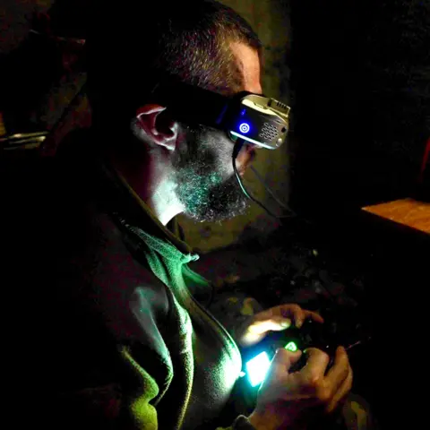 BBC A Ukrainian drone operator controlling a drone while wearing a virtual reality headset