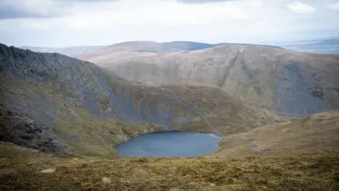 Scales Tarn glacial lake beneath Sharp Edge of Blencathra mountain