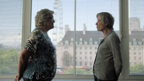 BBC Twins Jackie and Gillian stand face to face