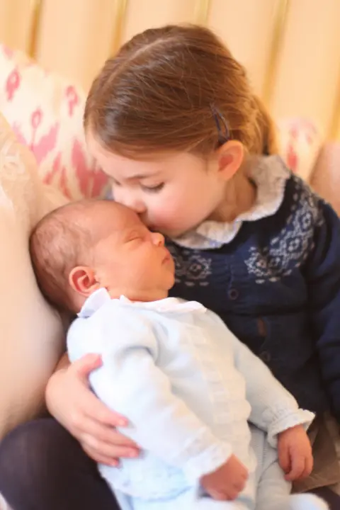 Duchess of Cambridge Third birthday portrait of Princess Charlotte, kissing baby brother Prince Louis on 2 May 2018